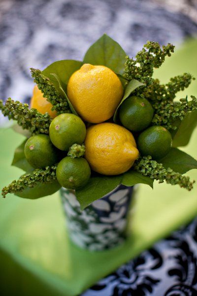 Lemons and limes as a bouquet in blue and white ceramic vase.